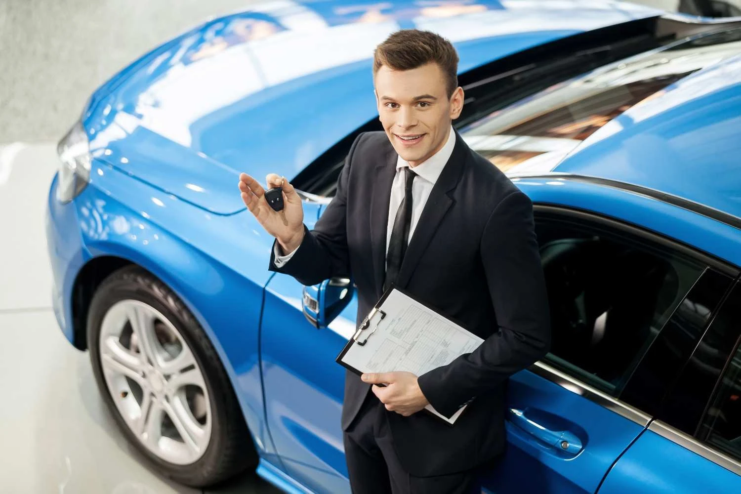 Car keys held up beside a policy form